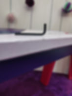 A black allen key on a bench
