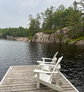 Freshly cleaned and set up dock and chairs on a Muskoka lake, part of Horizon Windows' odd jobs and cottage services.