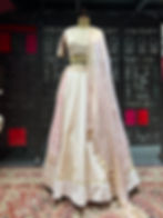 Ivory & pink lehenga with an embroidered panel & crinkled dupatta with tassels. Artisanal couture for day weddings by TASTA.
