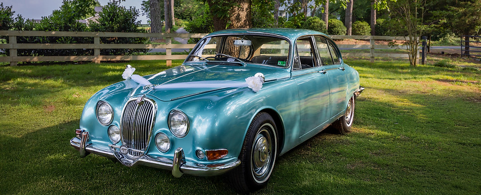 Turquoise 1966 Jaguar named The Duchess with right-hand drive, ideal for weddings, film scenes, and classic car lovers