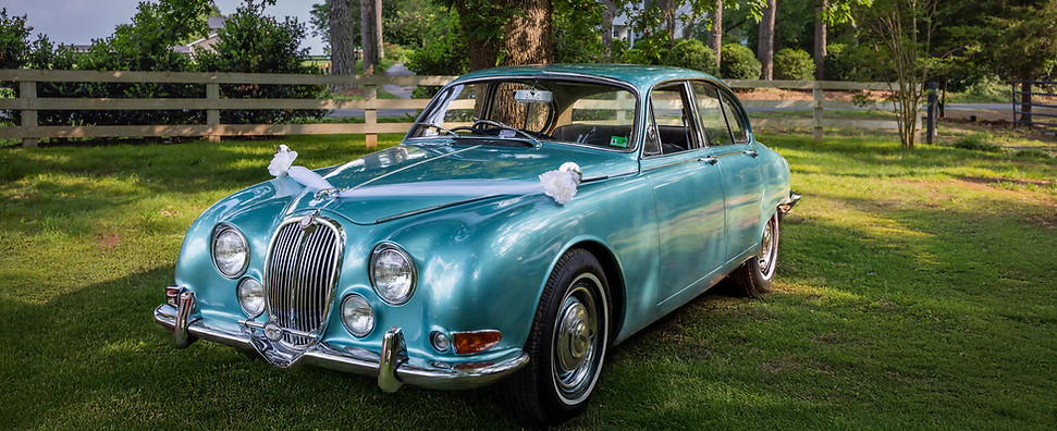 Turquoise 1966 Jaguar named The Duchess with right-hand drive, ideal for weddings, film scenes, and classic car lovers