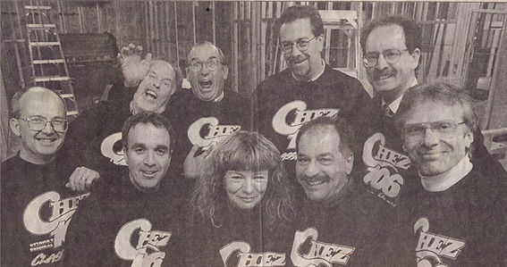 Michael Anthony and veteran CHEZ staff in skeleton of building designed by Michael Anthony before the Rogers takeover