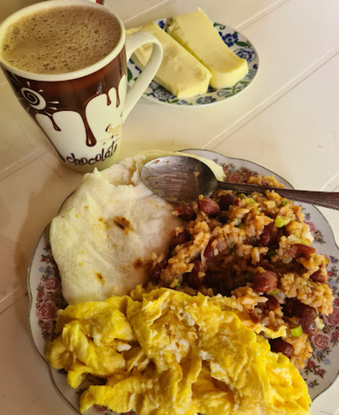 traditional colombian breakfast with eggs beans rice arepa