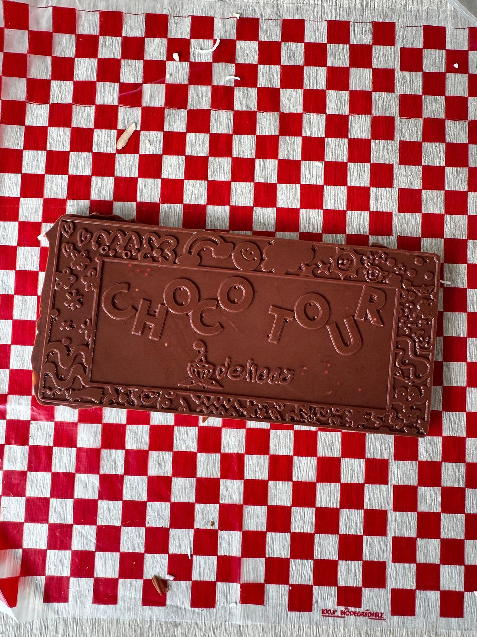 chocolate bar that reads choco tour on top of a red-white squared table