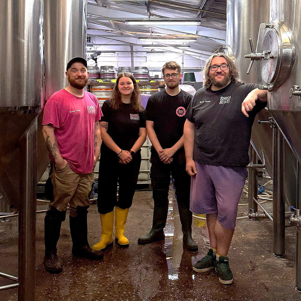 Four members of staff stood in a beer store
