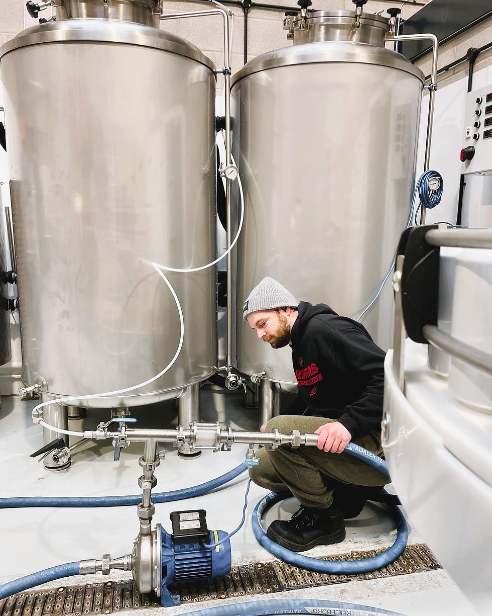 A man working on some pipes in a beer store
