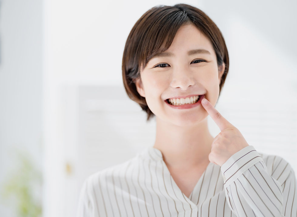 歯を指す笑顔の女性