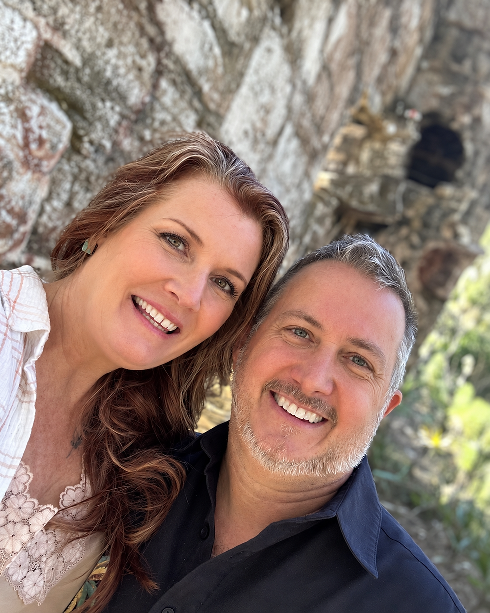 Bryan and Beth Griffin smiling together at the historic Dummett Sugar Mill Ruins near Ormond Beach, Florida.