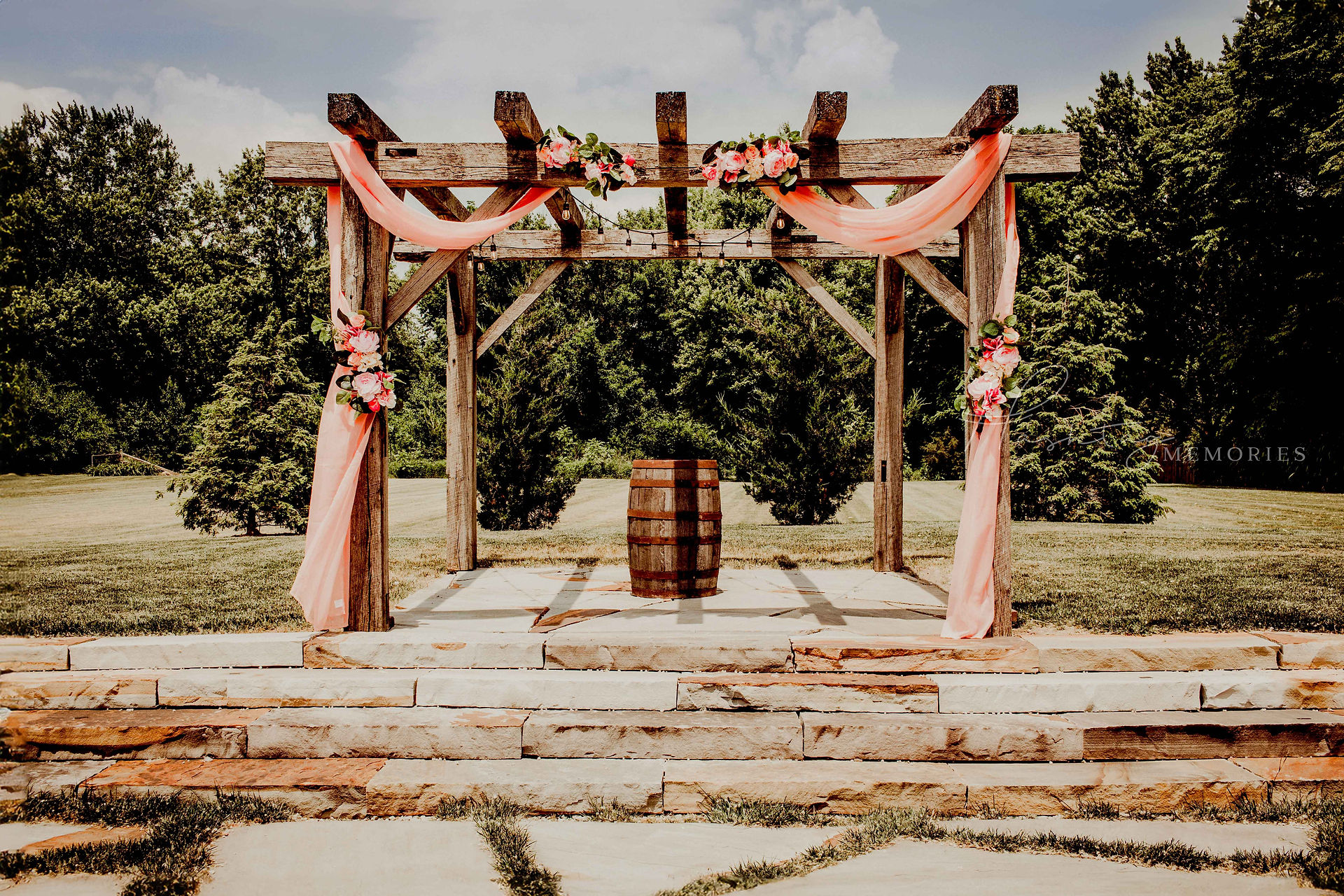 outdoor ceremony alter at the crystal coop wrapped in coral pink silks and white and pink florals