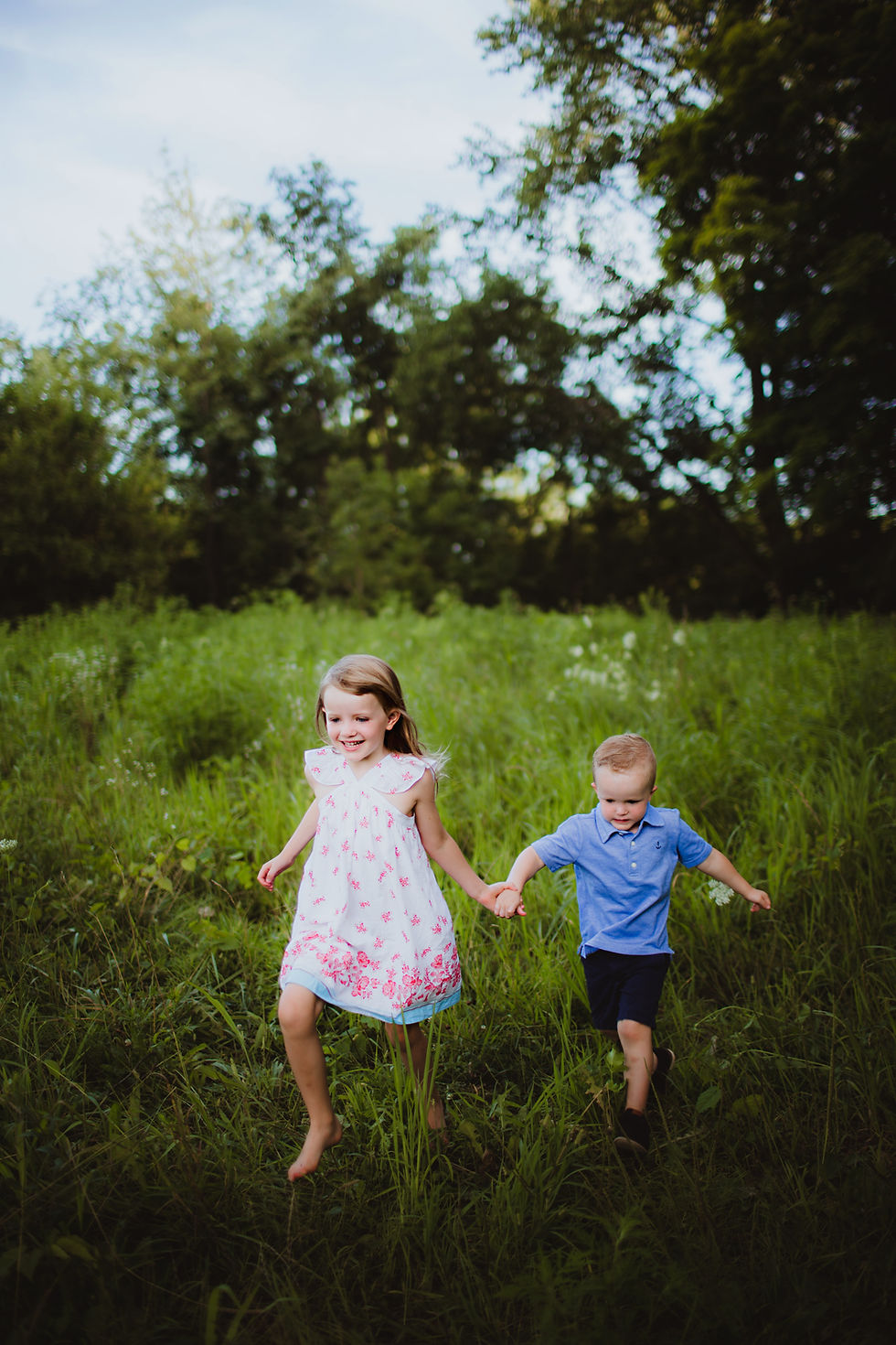 brother and sister playing in Noblesville, Indiana field during family photos
