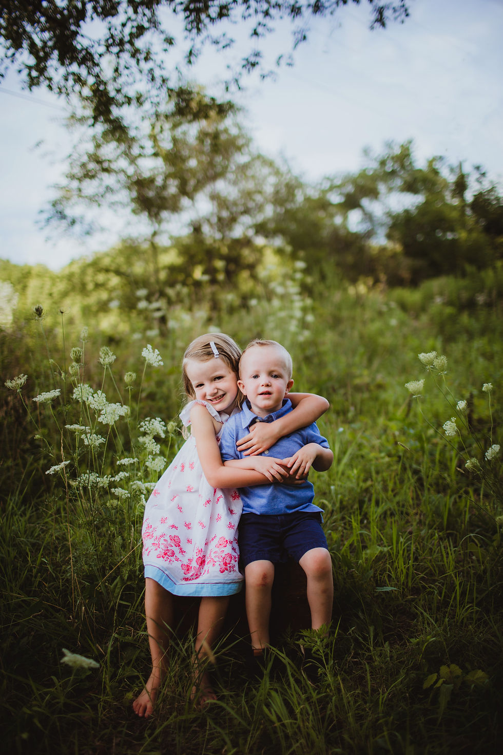 brother and sister pose in wildflower field during Indianapolis Family Photos