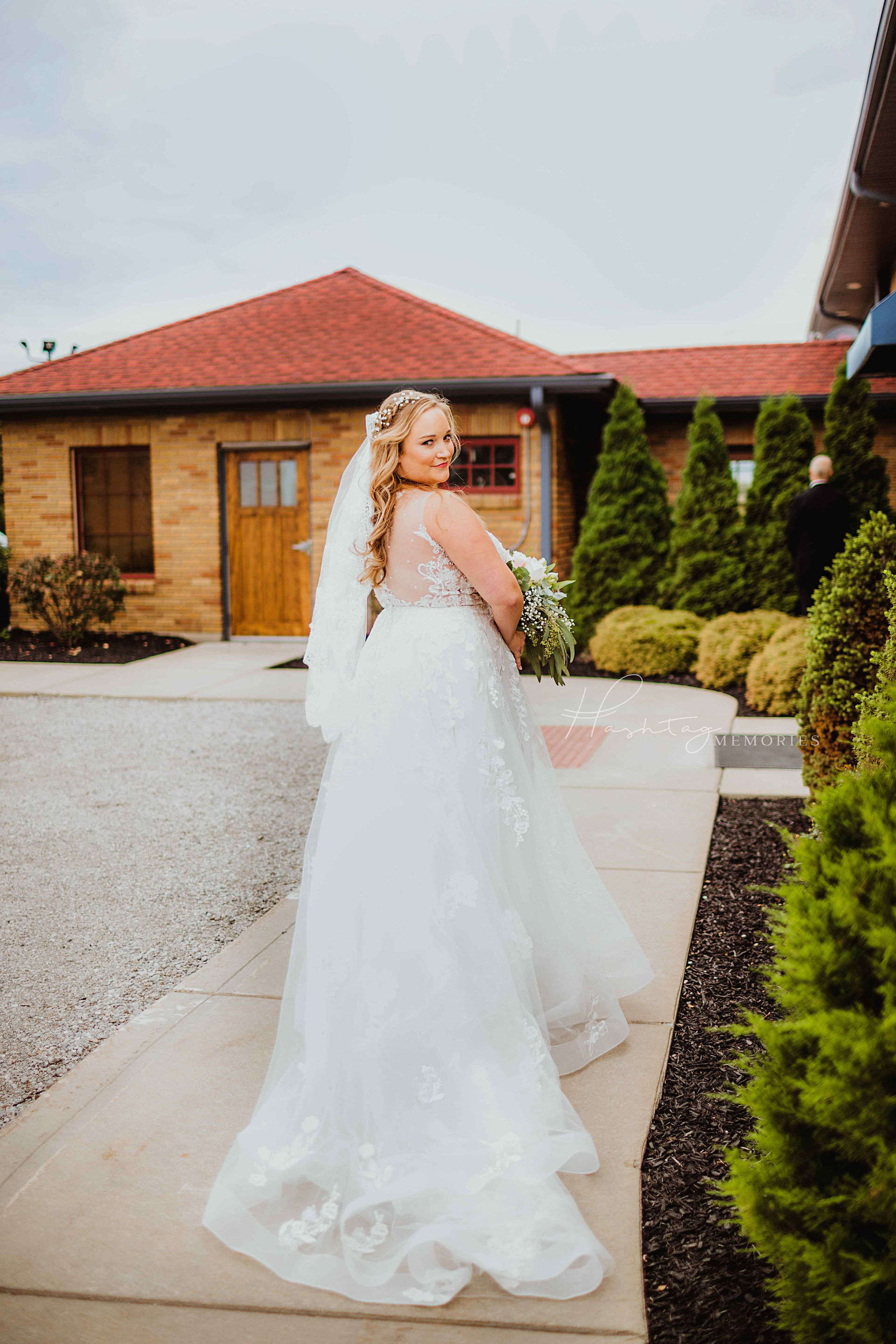 bride in illusion lace and crystal ballgown from I Do Bridal Boutique of fort wayne. Bride is getting ready to do a first look with her father on her wedding day at Sylvan Cellars Wedding Venue