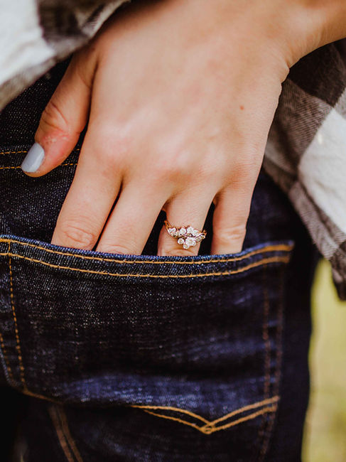 couple poses show casing floral engagement ring from local columbus indiana jeweler during their engagement session in westfield indiana by hashtag memories photography