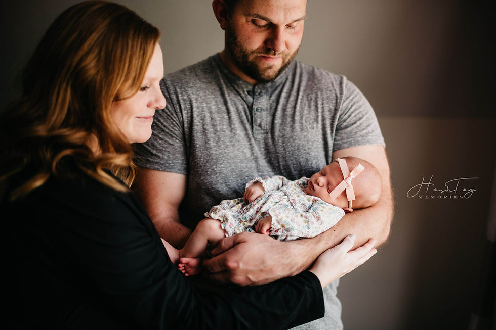 mom and dad holding newborn, Anderson Newborn Photographer
