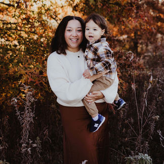 mother holds son during fall family photos