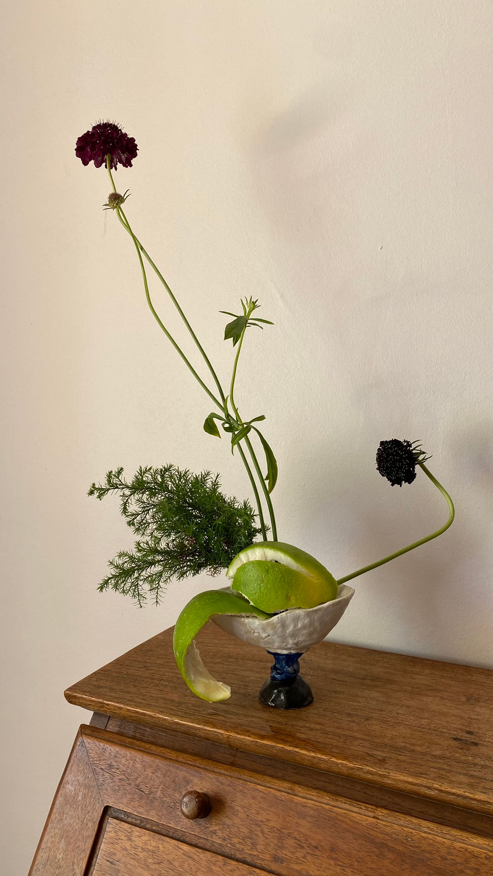 a vase filled with flowers and a lemon peel