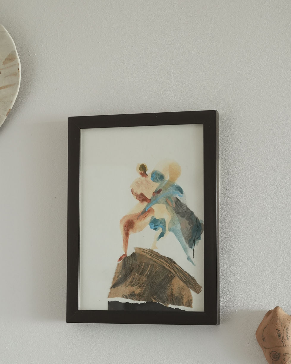 a framed painting of two people standing on a rock
