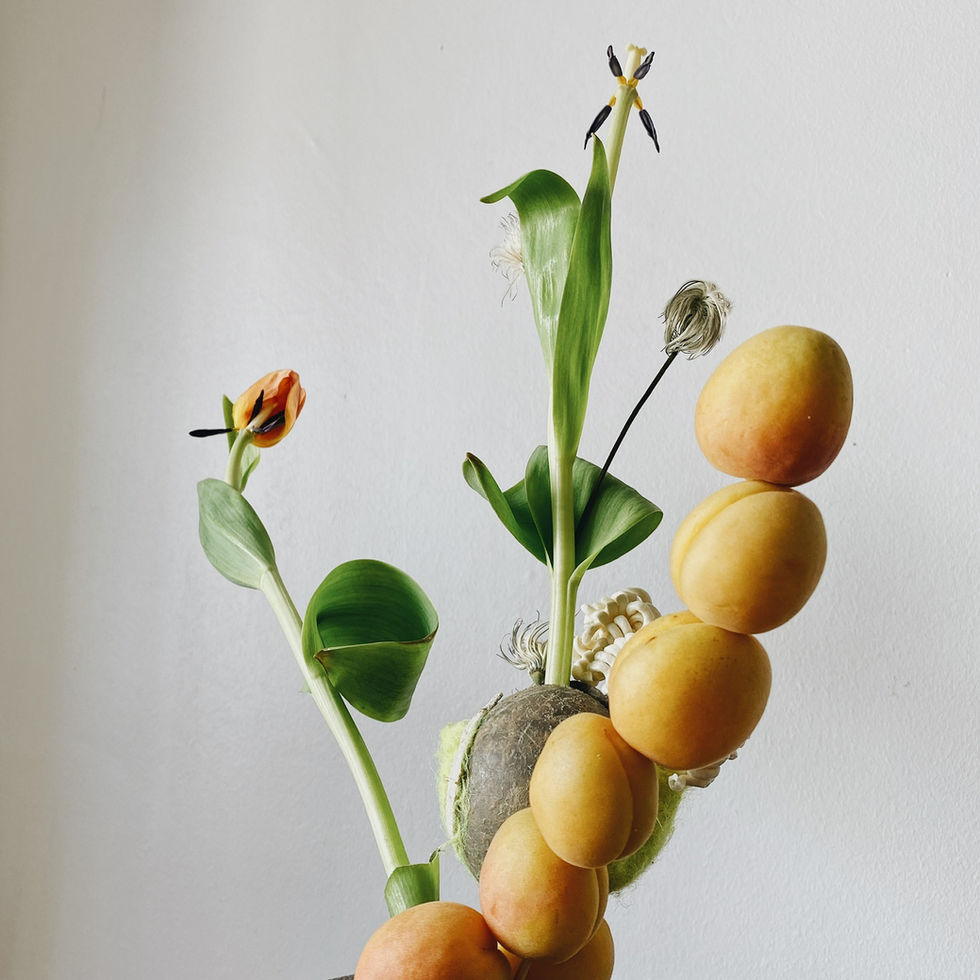 a bunch of fruits and flowers are stacked on top of each other