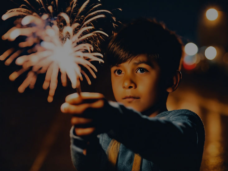 close up portrait of boy in the night holding a firework .jpg