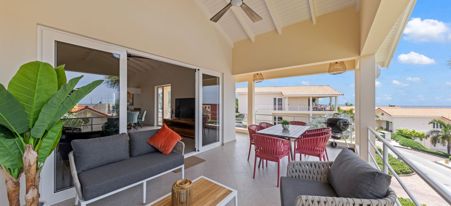 Spacious covered terrace with comfortable lounge seating.