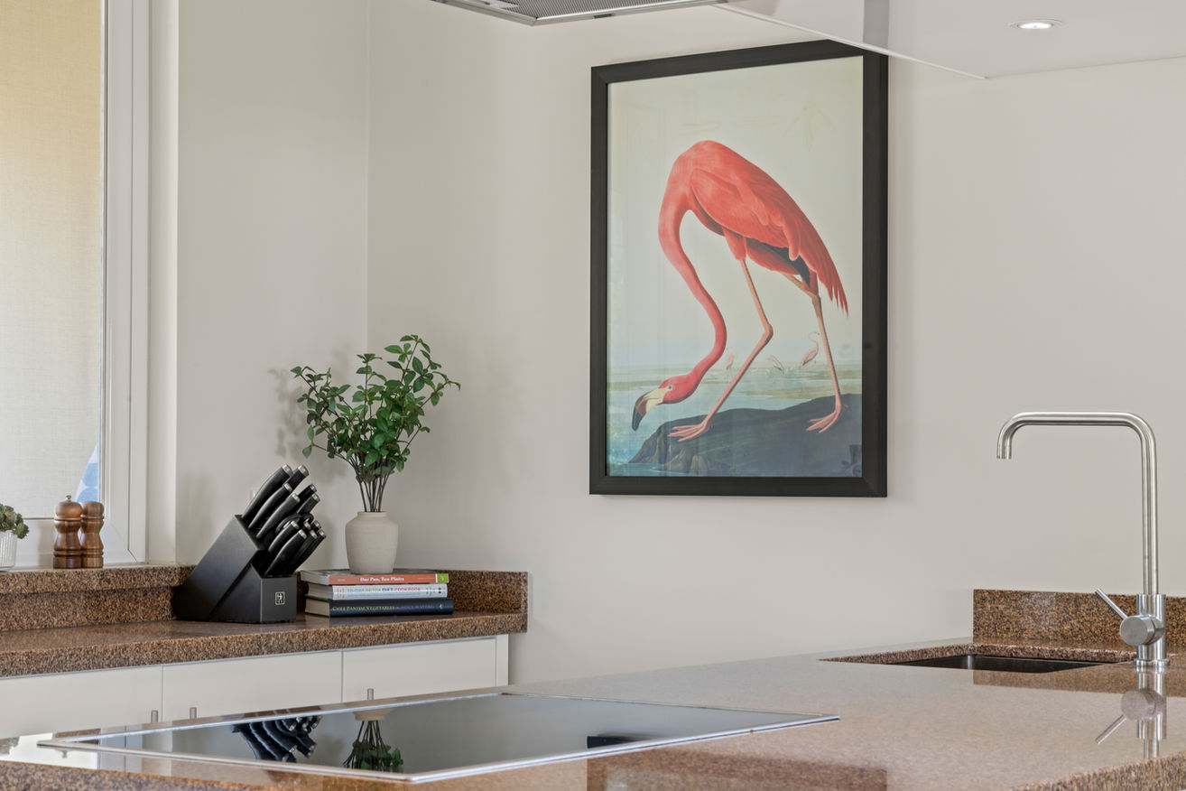Touches of style and art bring warmth to this contemporary kitchen.