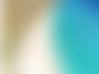 Aerial view of Klein Curaçao’s long white-sand beach, dotted with thatched palapa umbrellas along the shore, meeting vibrant turquoise waters where a few small boats float just offshore.