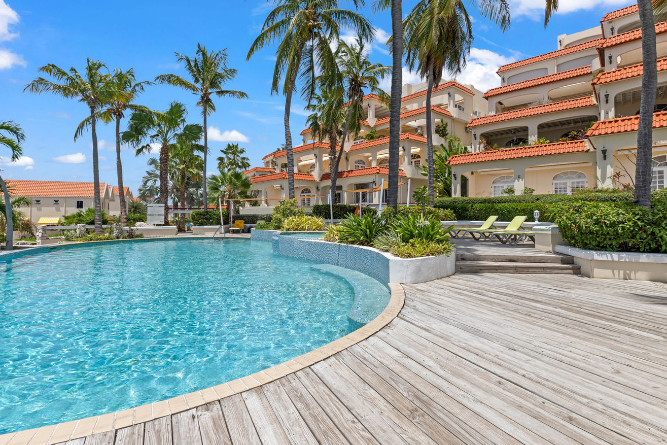 Sparkling pool with palm trees and ocean breezes — your private slice of paradise.