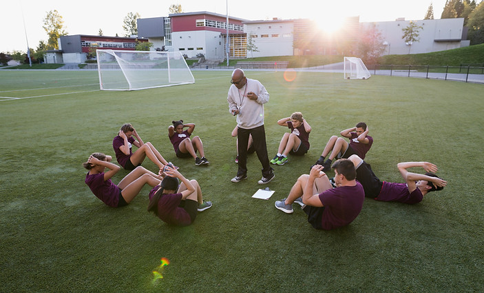 Basketball Players Listening to Coach