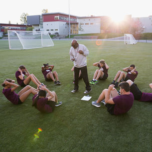 Player engaging in warm up under coach guidance