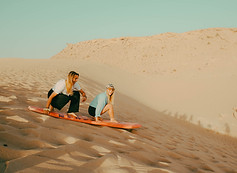 Women on sand dunes in Timlaline Morocco