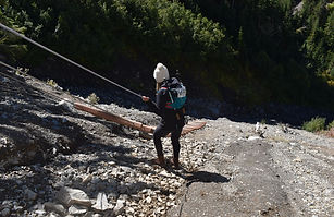 This is an image of Ari preparing to climb down a ladder bridge on one of her backpacking trips to Blue Glacier in the Hoh rainforest.