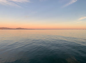 This is an image taken by Ari of a sunset over a waterway.