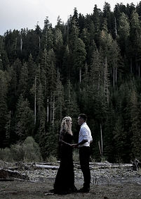 This is an image of Ari and her partner with a background of trees.