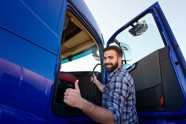 professional-truck-driver-entering-his-truck-long-vehicle-holding-thumbs-up.jpg
