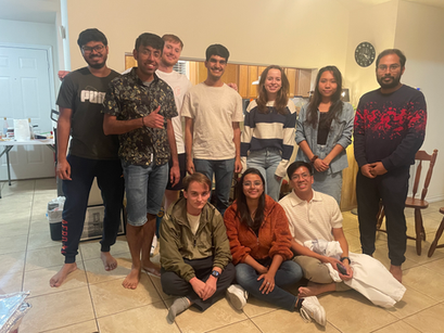 Most members of the group pose for a group photo in Deepta's living room.