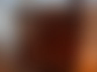 Restored 1930s walnut burl dresser with black painted frame and brass hardware, staged with a plant and vase in front of a window.