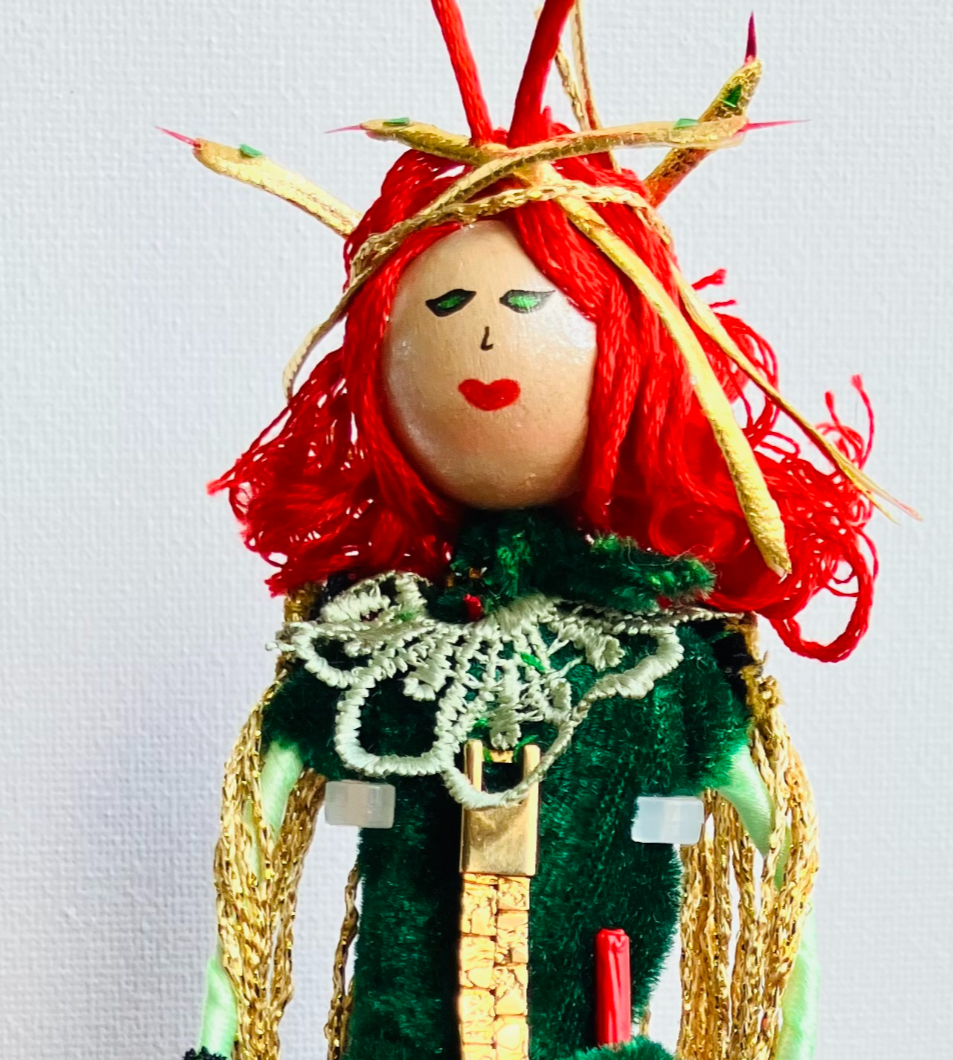 medusa doll with red hair and green dress close up