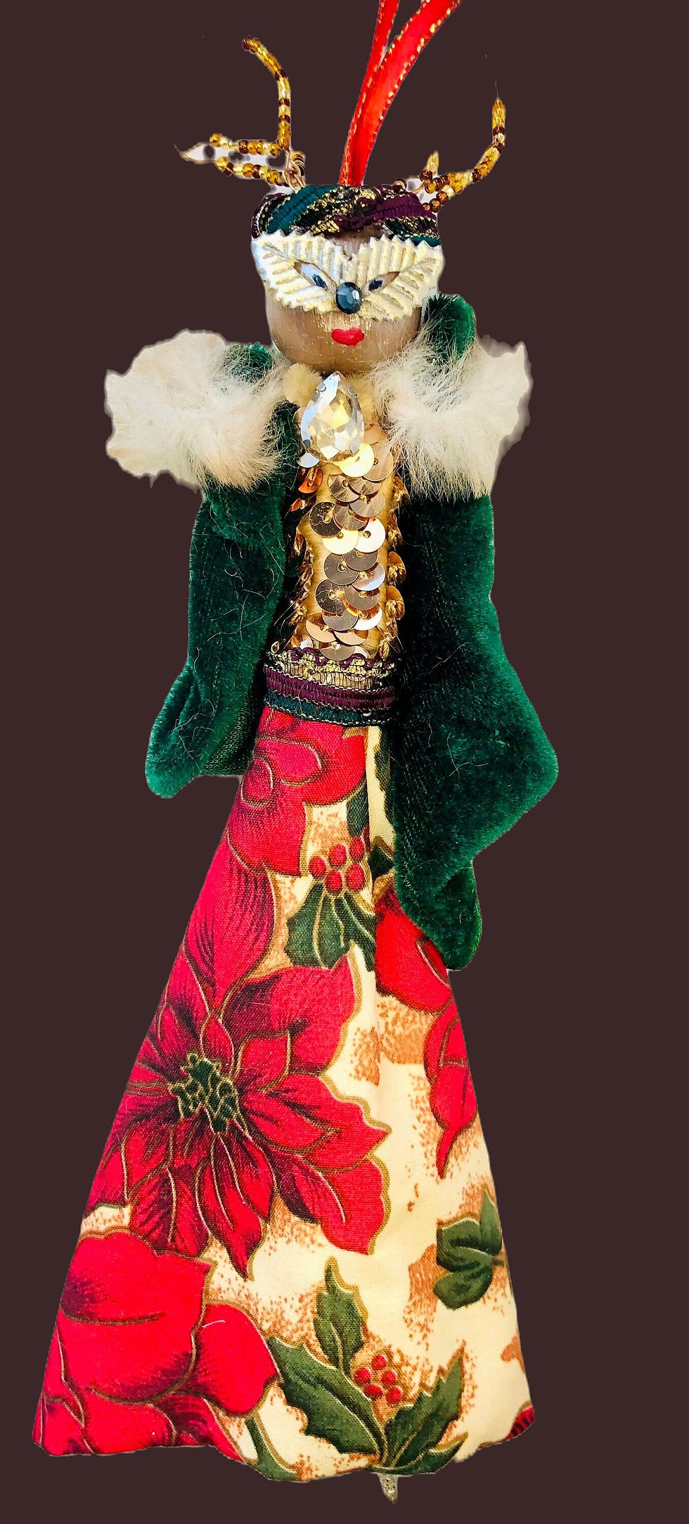 festive reindeer doll wearing a gold sparkling top with green sleeves and a floral skirt