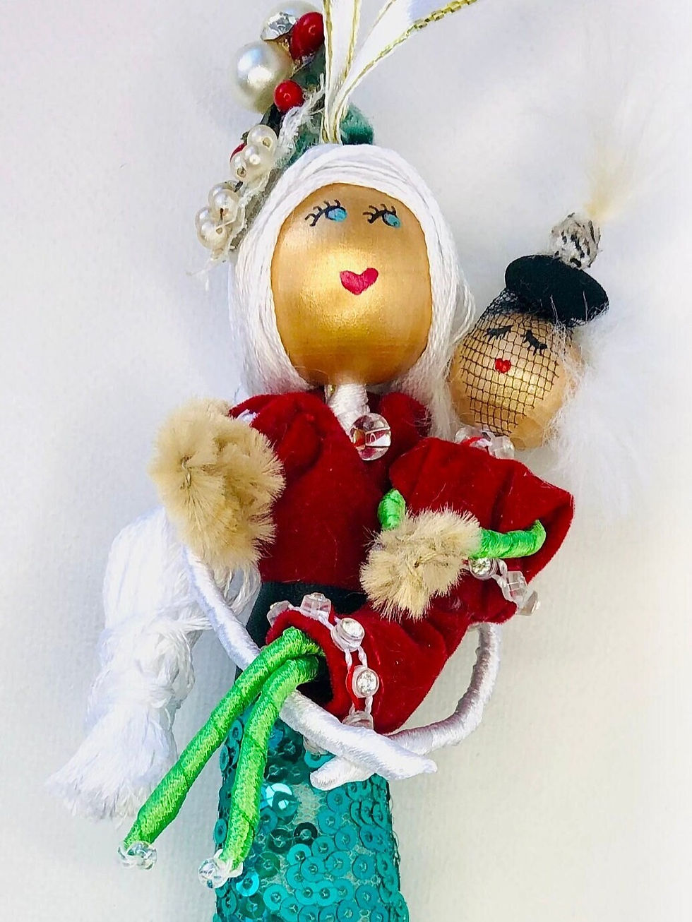 mrs. claus holding her daughter wearing red