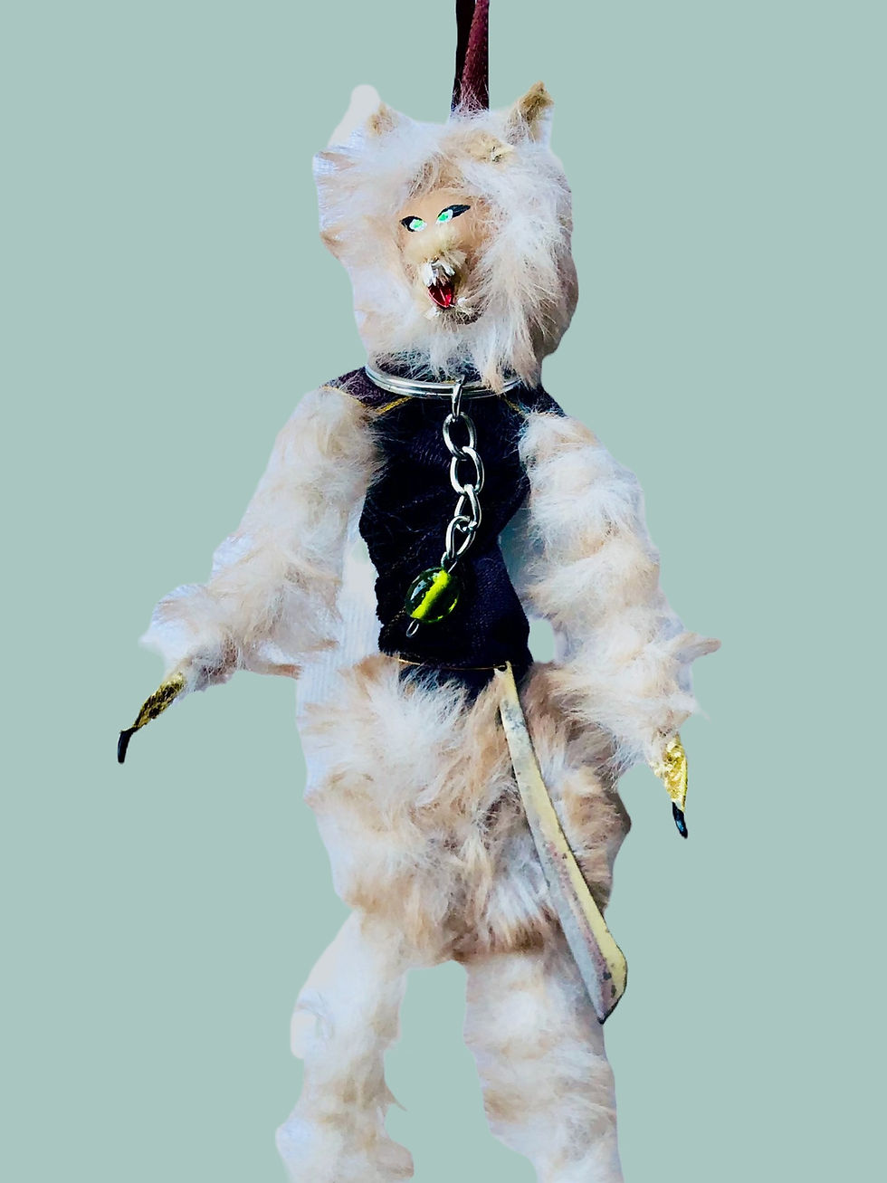 white and cream furry werewolf doll with machete