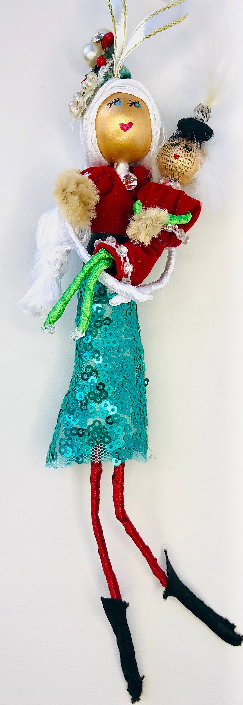 mrs. claus holding her daughter wearing red