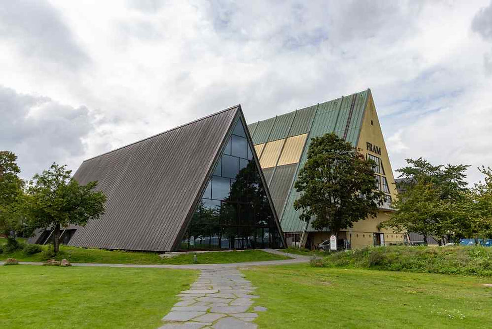 Angular modern museum building with green roof and FRAM sign beside a grassy path under a cloudy sky