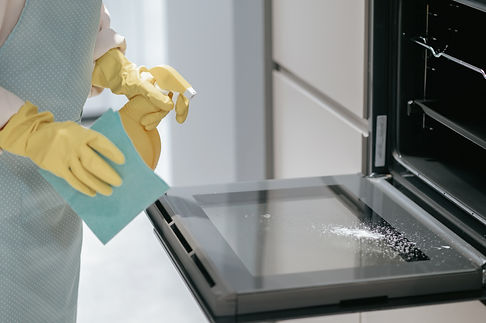 service-person-cleaning-kitchen-appliances.jpg