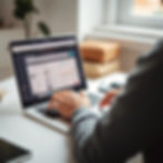 A person participating in an online auction on a laptop with a blurry screen, clean and mi