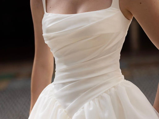 Basque waist wedding dress with a draped satin bodice and full skirt from the Essense of Australia 2026 bridal collection.