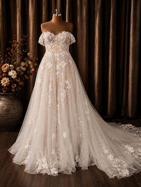 Romantic off-the-shoulder A-line wedding dress with floral lace appliqués, sparkling tulle and a sweeping train.