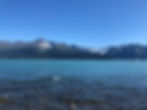 Snow-capped mountains reflected in a calm lake