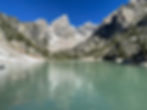 Alpine lake reflecting snow-capped mountain peaks