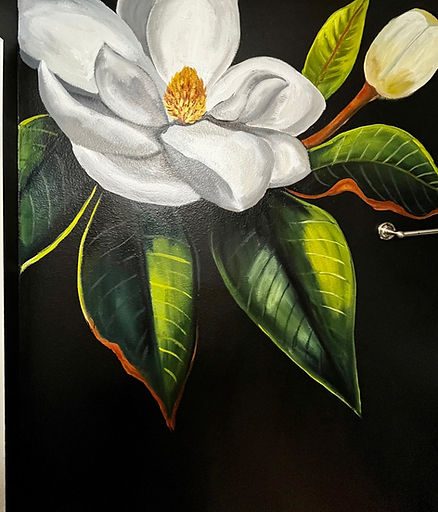 A large painted magnolia on the wall inside a residential property.