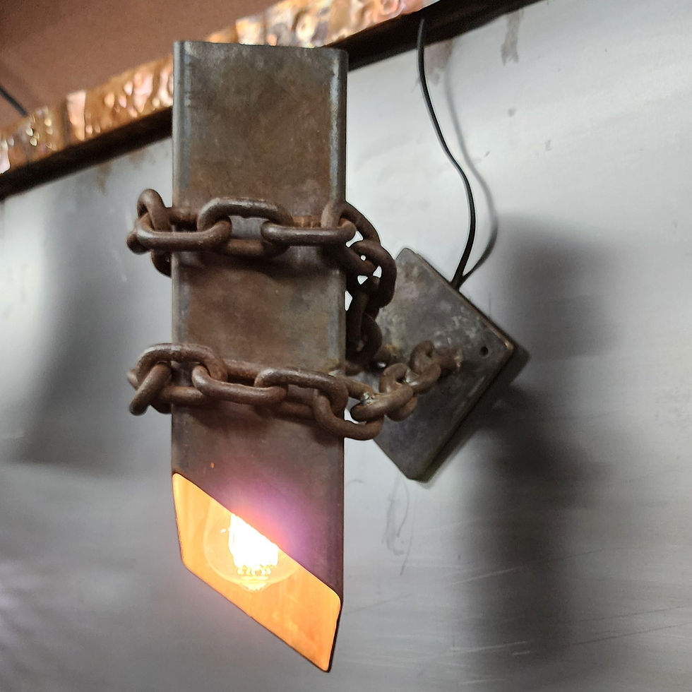 Thumbnail: lit industrial wall sconce with warm glow from exposed bulb inside steel housing